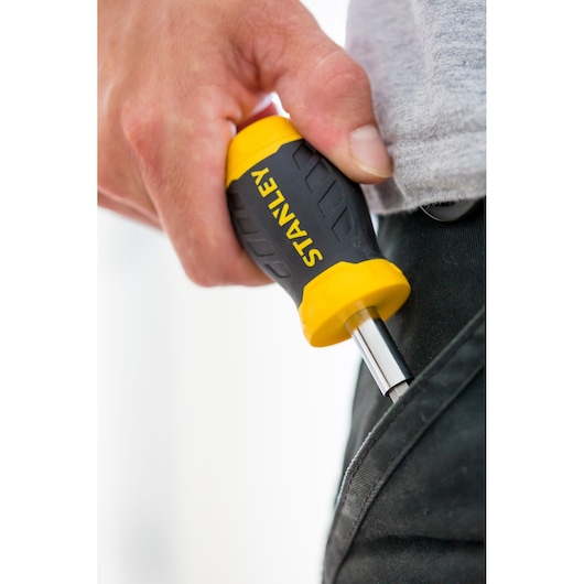 STANLEY 0-66-357 screwdriver with yellow and black handle, close-up view being held near a pocket.