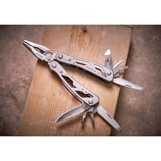 STANLEY 0-84-519 multi-tool with pliers and fold-out tools on wooden surface
