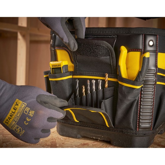 STANLEY 1-93-952 tool bag photography showing organized drill bits, pliers, and tape measure in exterior pockets.