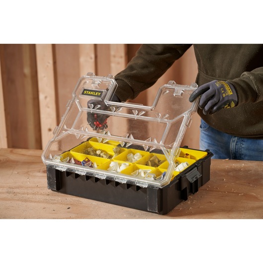 STANLEY 1-97-521 organizer with clear lid, black base, and yellow compartments, shown open on a workbench.