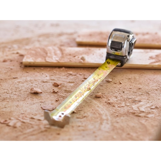STANLEY 5-33-886 tape measure extended on a dusty work surface, close-up photography.