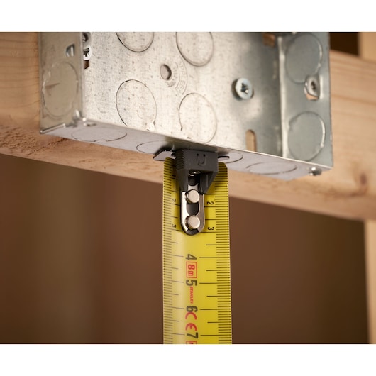 STANLEY FMHT0-33868 tape measure close-up, yellow blade measuring metal box, front angle.