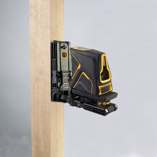 STANLEY FMHT1-77348 laser level device mounted on wood, side angle, black and yellow housing.