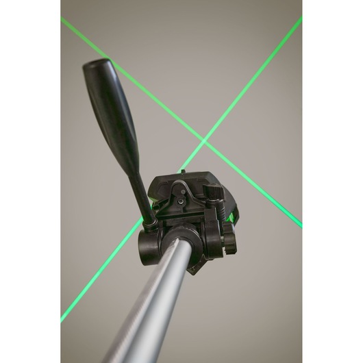 STANLEY FMHT1-77356 laser level on tripod projecting green cross lines, photography close-up view.