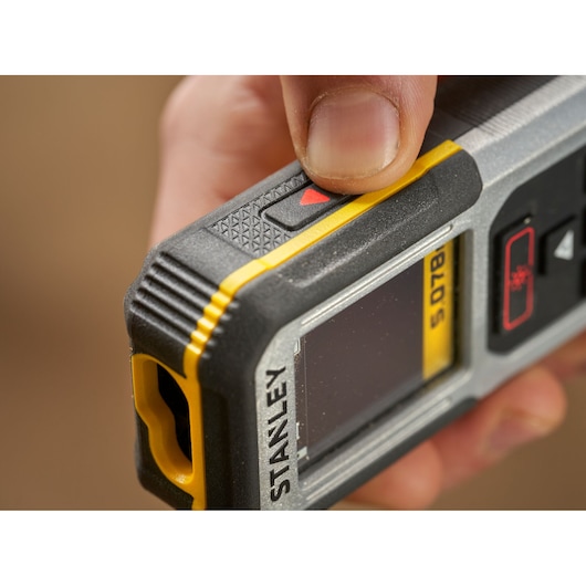 Photo of STANLEY FMHT77050-XJ laser distance measurer close-up, showing its display and buttons.