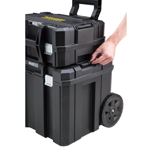 STANLEY FMMT98108-1 black rolling tool box stack with handle, shown from side with hand unclipping latch.