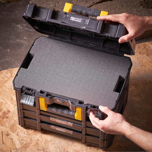 STANLEY FMST1-72365 modular storage box with foam insert, shown open from above on a wooden surface.