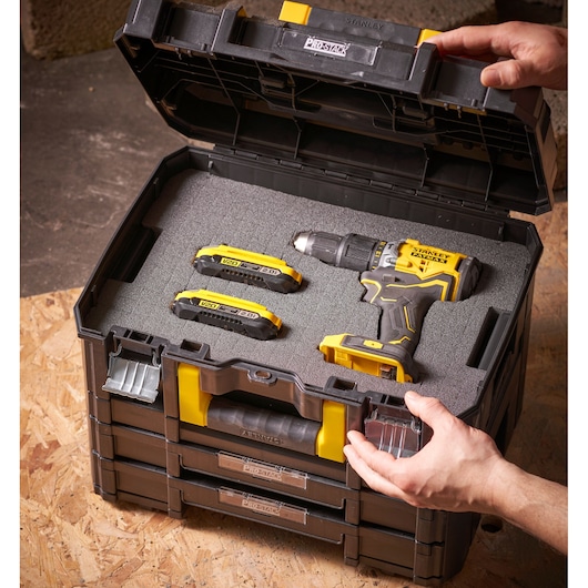 STANLEY FMST1-72365 ProStack toolbox open with yellow-black drill and two batteries in foam insert.