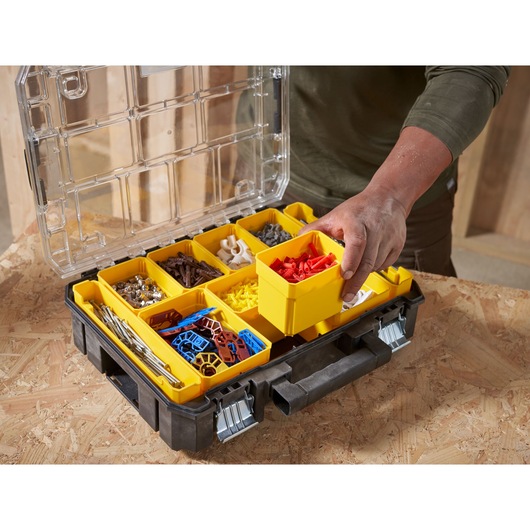 STANLEY FMST82967-1 organizer box with yellow removable bins for hardware, top view, in workshop setting.