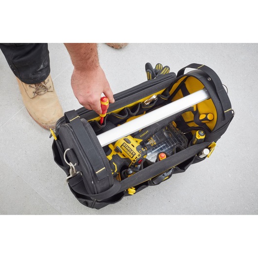 STANLEY FMST83296-1 tool bag top view showing organized tools and yellow accents in use.