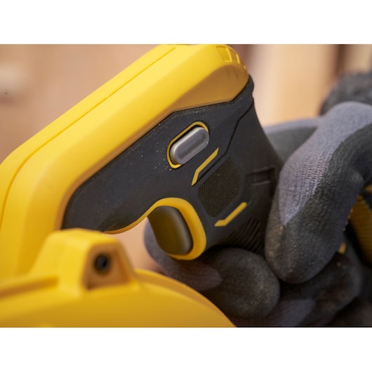 STANLEY SFMCBL01B photography close-up of black and yellow tool handle with trigger, gloved hand holding.
