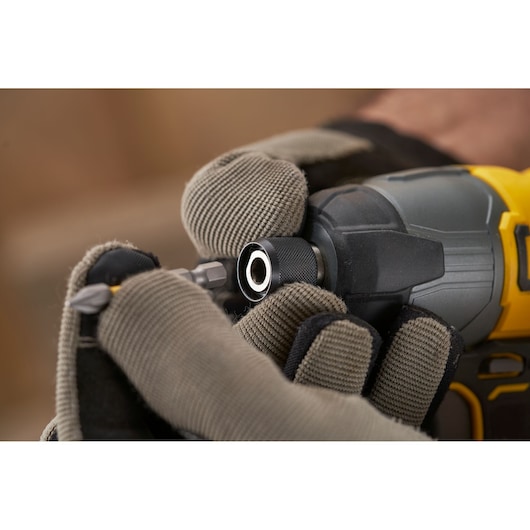 STANLEY SFMCF800C2K cordless impact driver close-up with gloved hands inserting bit.