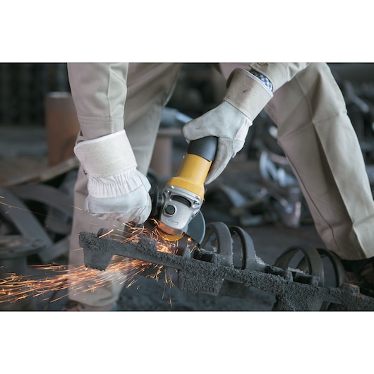 STANLEY SGS1045 angle grinder in use, emitting sparks while cutting metal, close-up action shot.
