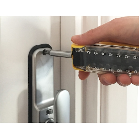 STANLEY STA62635 screwdriver being used to install a silver door handle close-up.