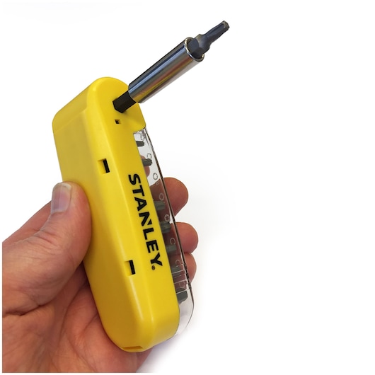 Stanley STA62635 yellow multi-bit screwdriver in hand, side angle, photography product.