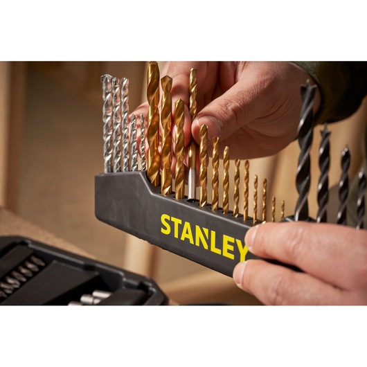 Stanley STA7184 drill bit set in holder, assorted gold and silver bits, close-up photography.