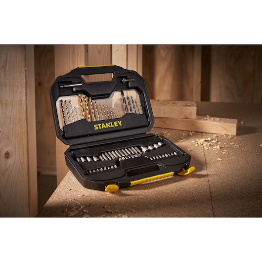 STANLEY STA7184 drill and bit set in open black and yellow case, shown on workshop table.