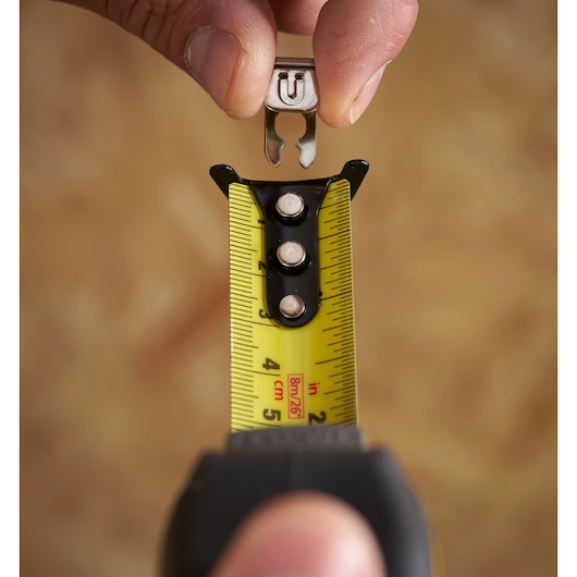 STANLEY STHT37236-5 tape measure photography, close-up showing detachable hook and yellow marked blade.