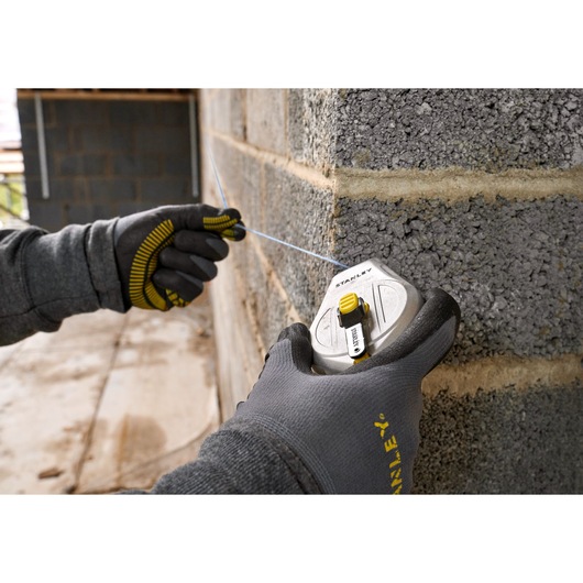 Stanley STHT47110-0 chalk reel photography showing use on concrete wall.