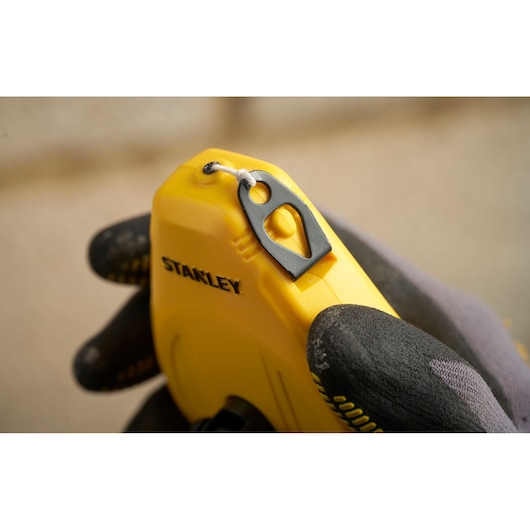 STANLEY STHT47112-0 chalk line reel in yellow held by gloved hand, close-up photography.