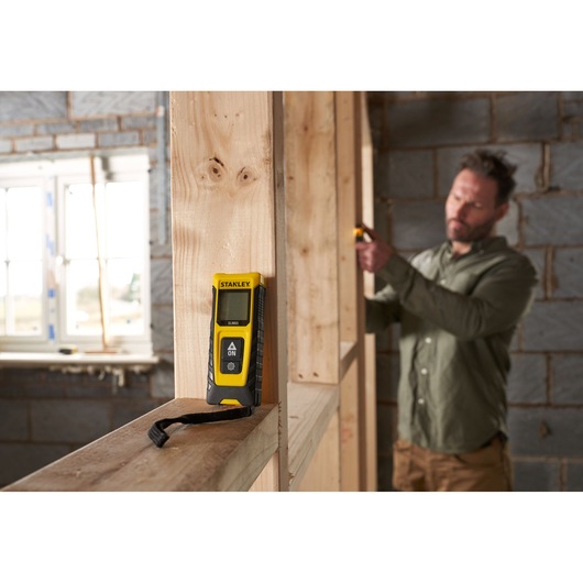 STANLEY STHT77065-0 laser distance measurer photography in construction setting.