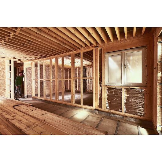 STANLEY STHT77666-0 photography of wooden framed house under construction with exposed beams and window.