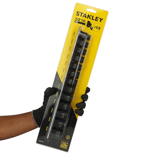 STANLEY STMT73916-8 13-piece 1/2" drive socket set MM, photo of packaging held in gloved hand, front angle.