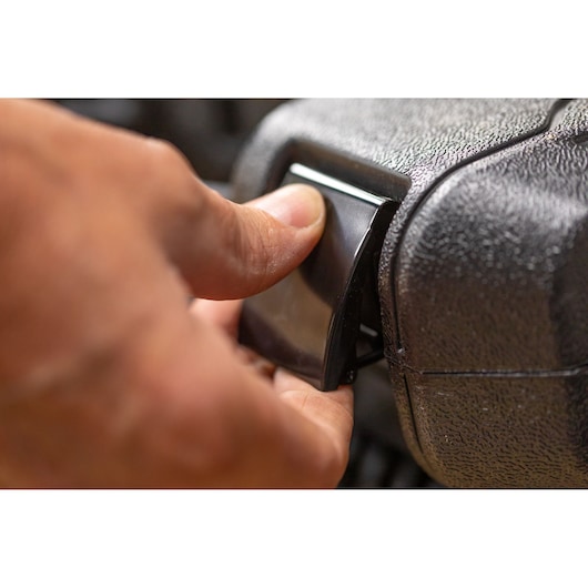 STANLEY STMT82829-1 close-up of hand pressing latch on textured black tool case.