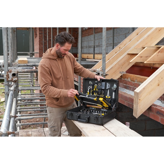 STANLEY STMT98109-1 maintenance suitcase with 142 tools open at construction site, showing organized tools.