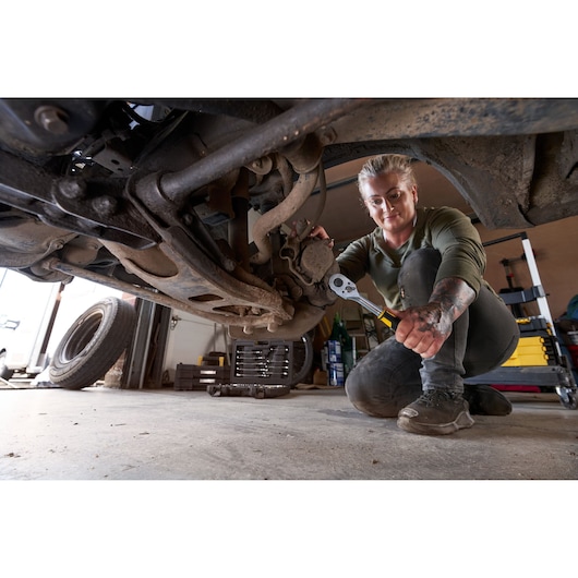 STANLEY STMT98109-1 maintenance suitcase in use under vehicle; tool visible next to yellow case.
