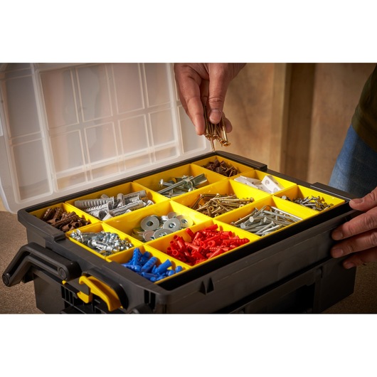 STANLEY STST1-75540 organizer box with yellow compartments holding assorted fasteners, top angle photo.