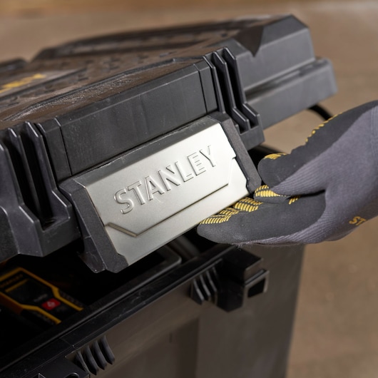 STANLEY STST33090-1 black and silver toolbox front latch, gloved hand opening