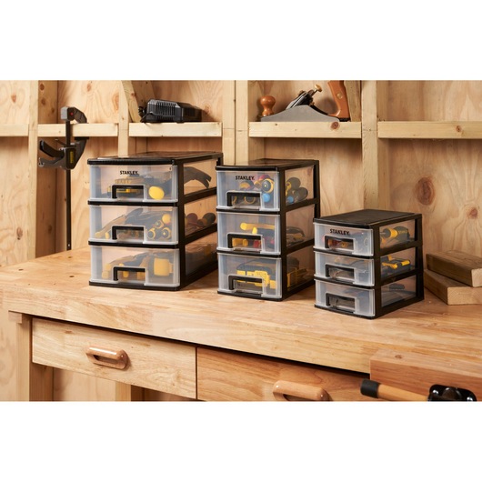 Photo of STANLEY STST40711-1 drawer organizers with tools on a wooden workbench in a workshop.