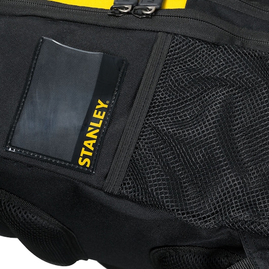 STANLEY STST515155 tool bag close-up, showing mesh pocket, ID card holder, black fabric and yellow accent.