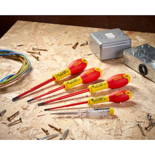 STANLEY XTHT0-62692 insulated screwdriver set with red and yellow handles, angled on a plywood surface.